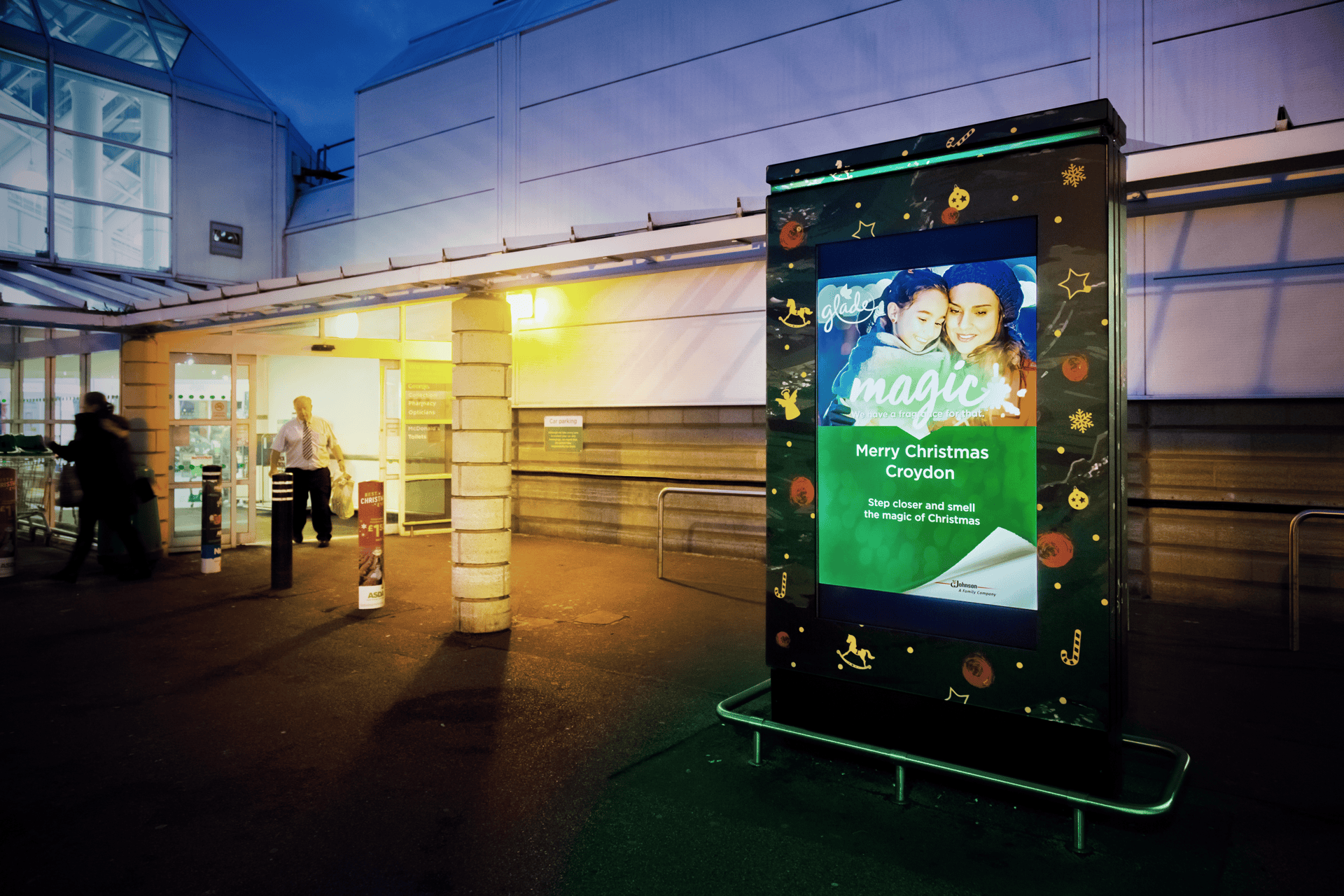 Digital signage advertising Christmas themed scent outside Asda supermarket.