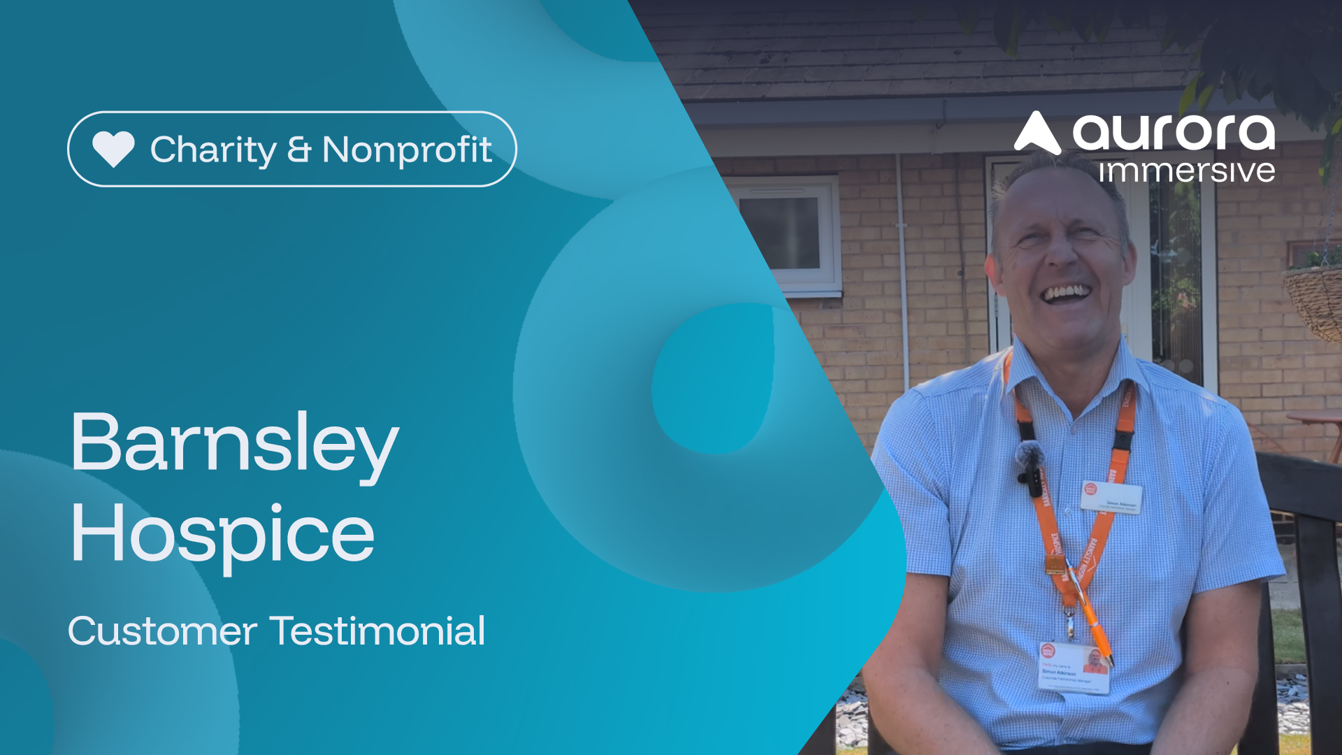 A smiling man sits outside in front of a building, wearing a blue shirt and lanyard. Text overlay reads “Barnsley Hospice Customer Testimonial” with charity and company logos.