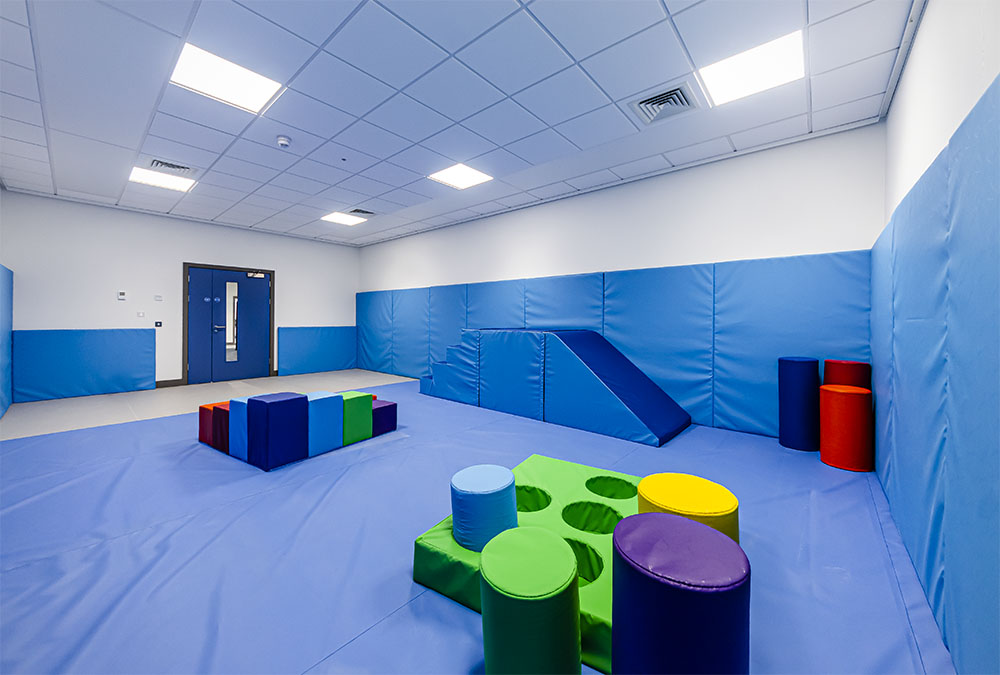 A soft play activity room with padded walls and flooring