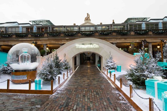 A bridge next to a life-size Tiffany & Co branded snow globe surrounded by snow, at Covent Garden in London.