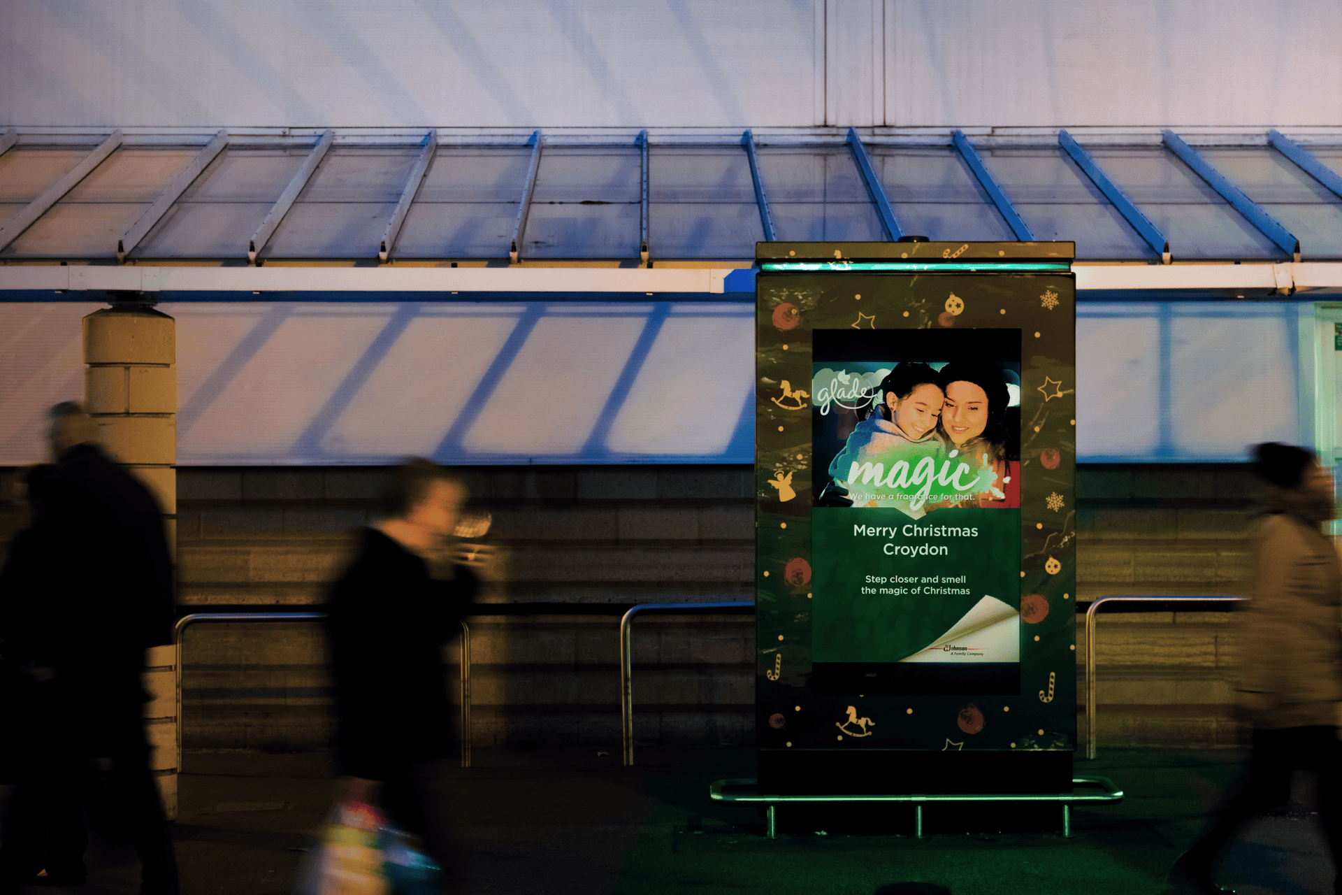 Digital signage advertising Christmas themed scent outside Asda supermarket.